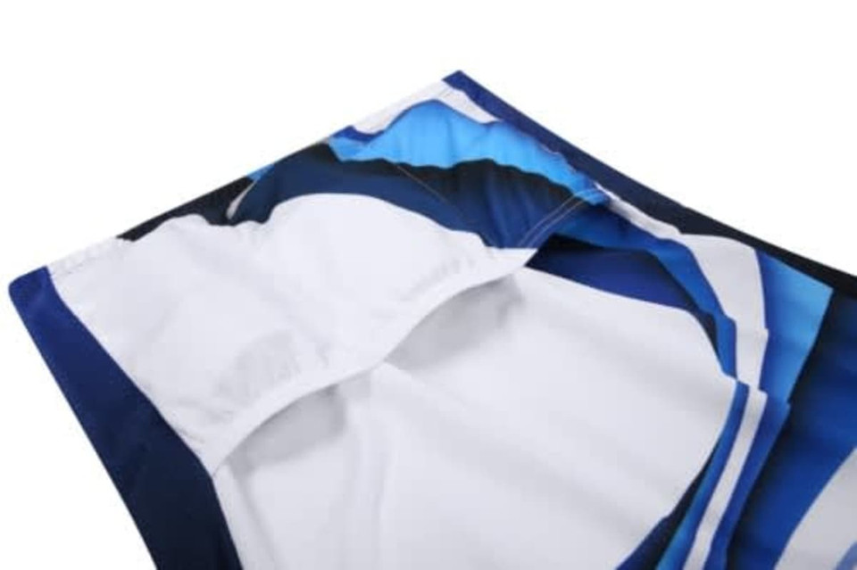 A close-up of a cycling jersey featuring blue and white designs, with stitching visible and a logo present.