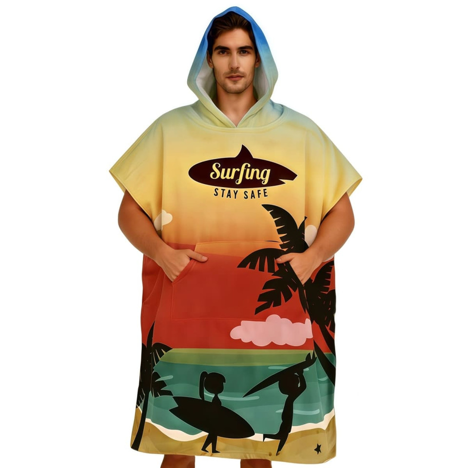 A colourful surf poncho with a hood, featuring a beach scene and palm trees, designed for comfort and style.