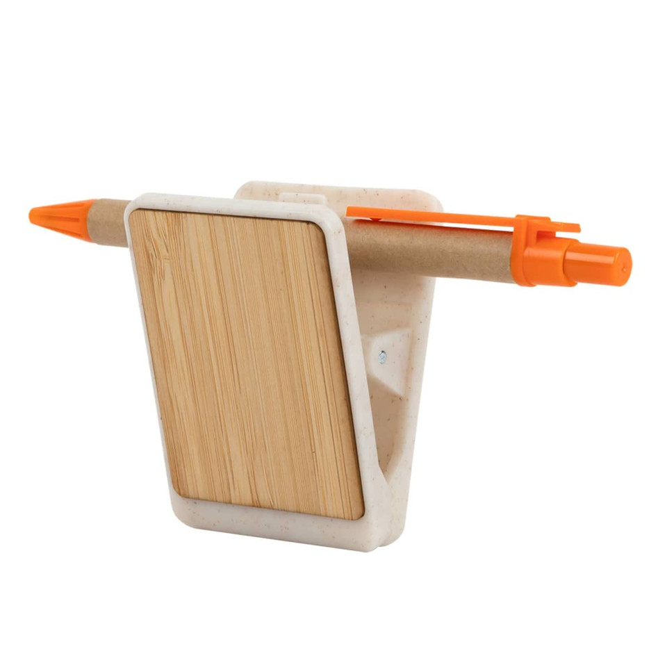 A magnetic clip holder in white with a bamboo back and an orange pen attached. Includes a space for notes.