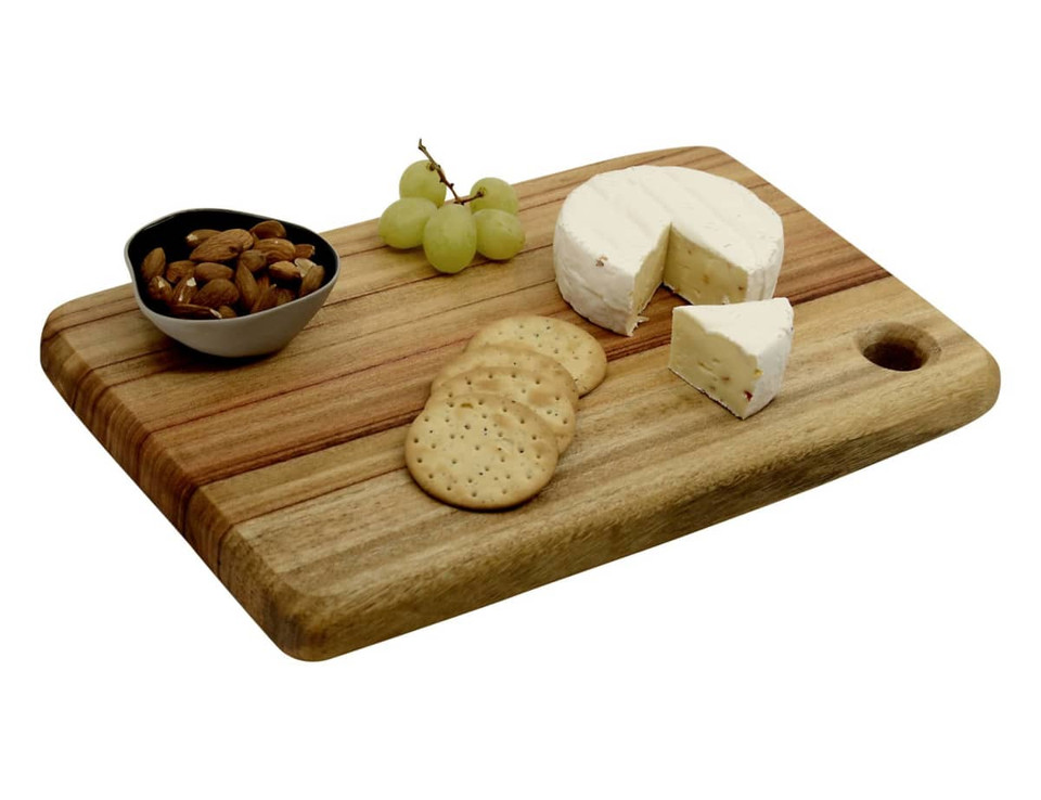A wooden cheese board with a creamy cheese wheel, crackers, almonds, and grapes, featuring a small bowl.