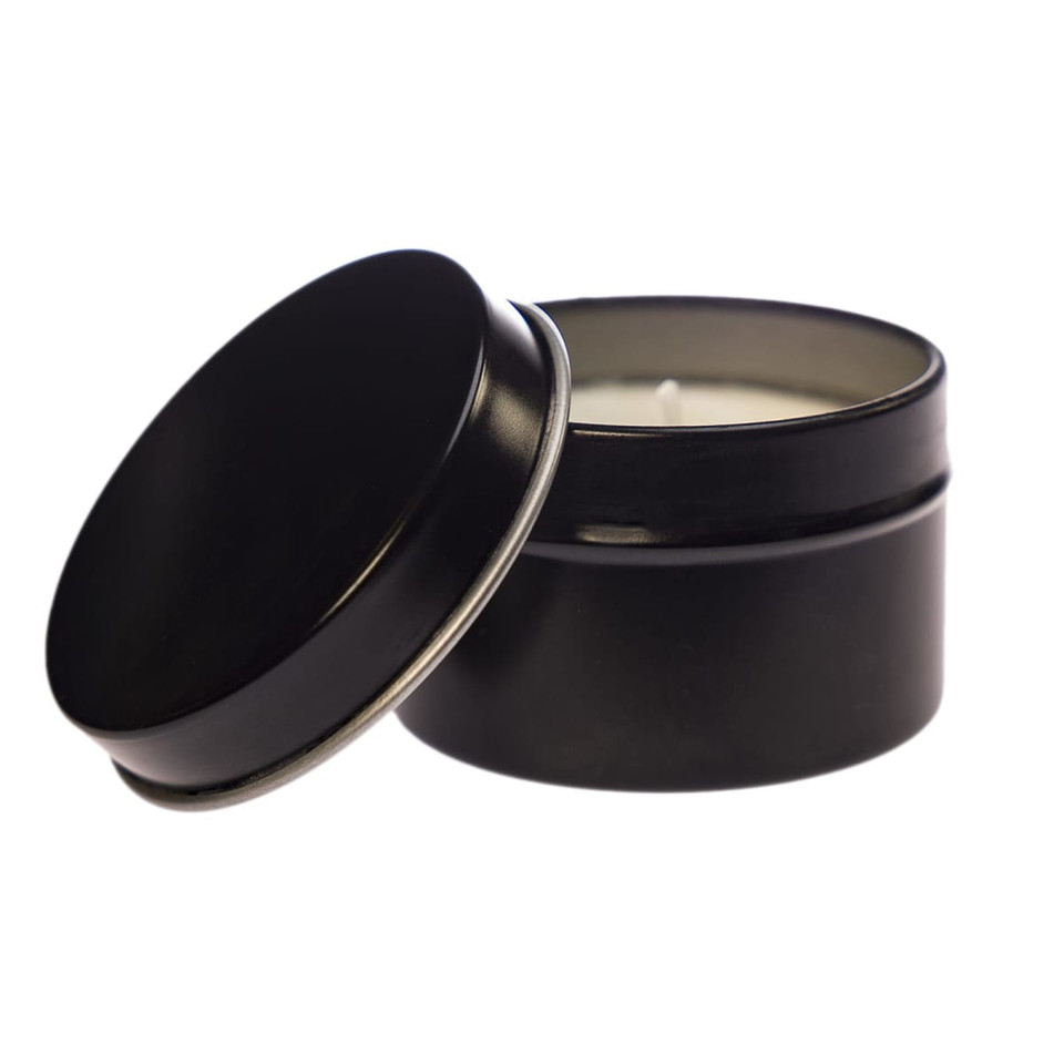 A petite black candle in a tin, featuring a removable lid and a candle wick.