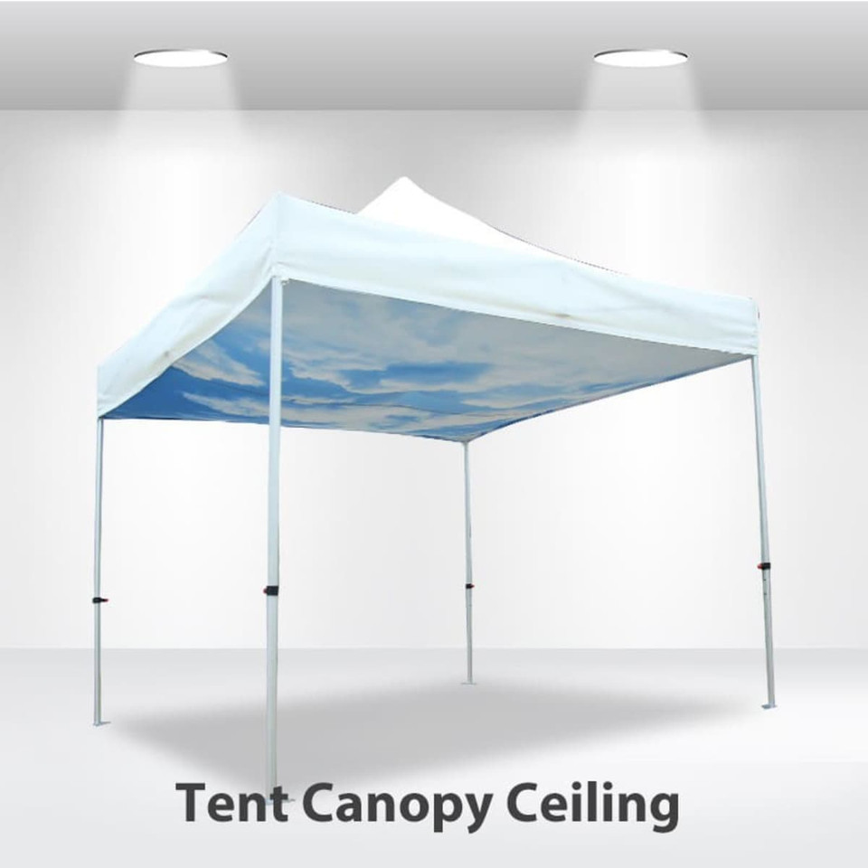 A white marquee tent with a blue sky design on the ceiling and four legs supporting it.