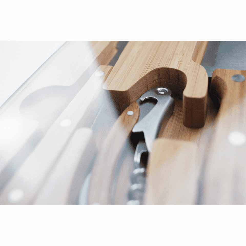 A bamboo knife set featuring various utensils and a corkscrew, presented in a sleek case with a glass lid.