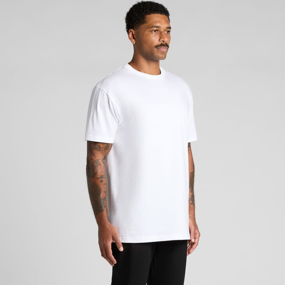 A white Block Tubular Tee worn by a model, featuring a simple design and a logo on the front.