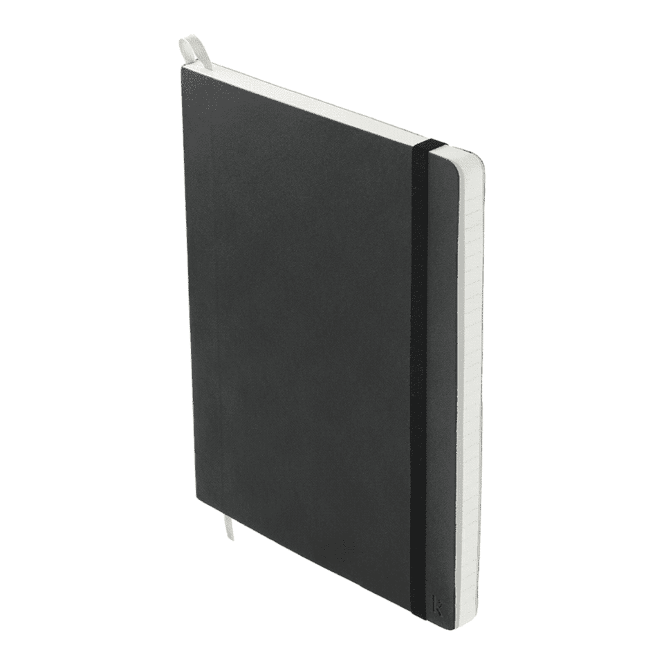 A softcover A5 notebook in black with a white ribbon bookmark and an elastic band closure. It has a logo on the cover.