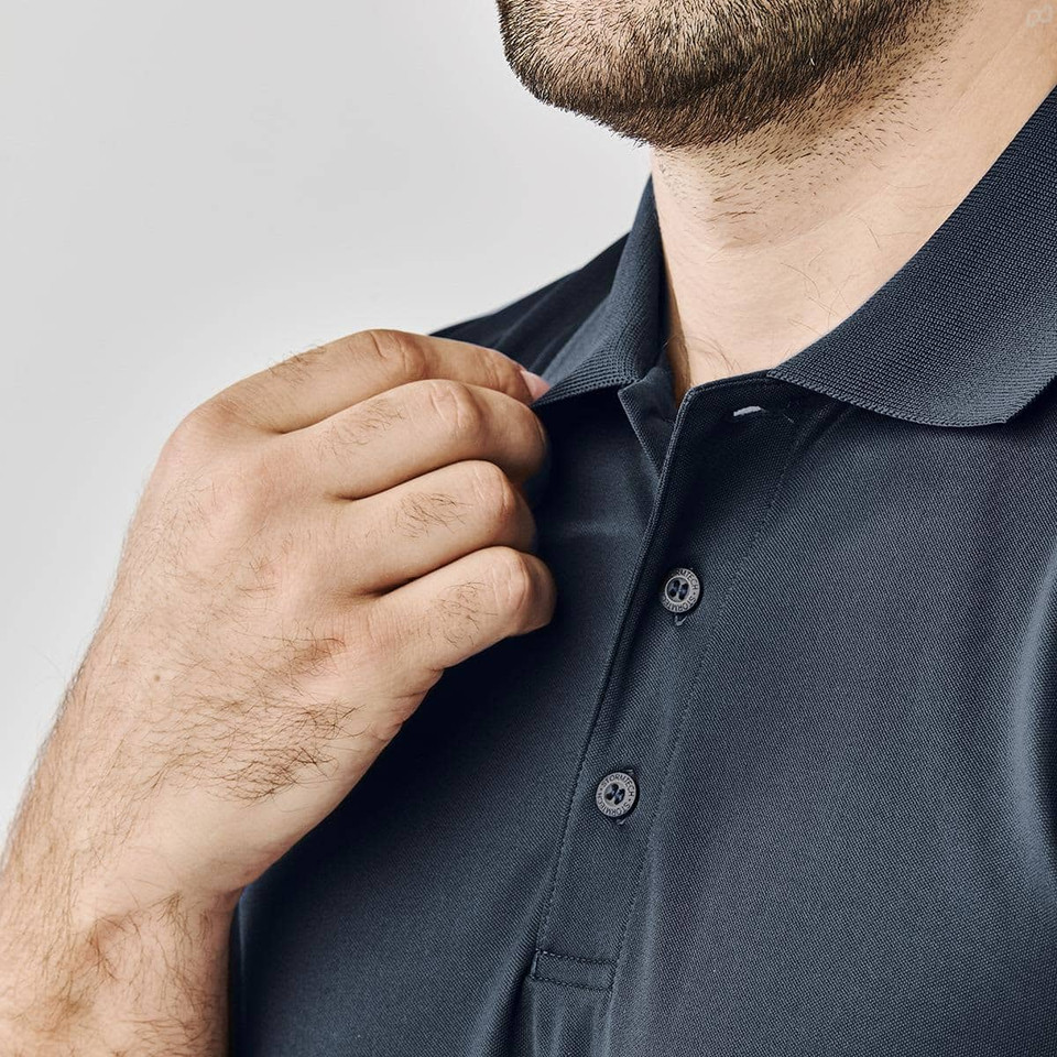 A close-up of a man's hand adjusting the collar of a black polo shirt featuring buttons and a logo.