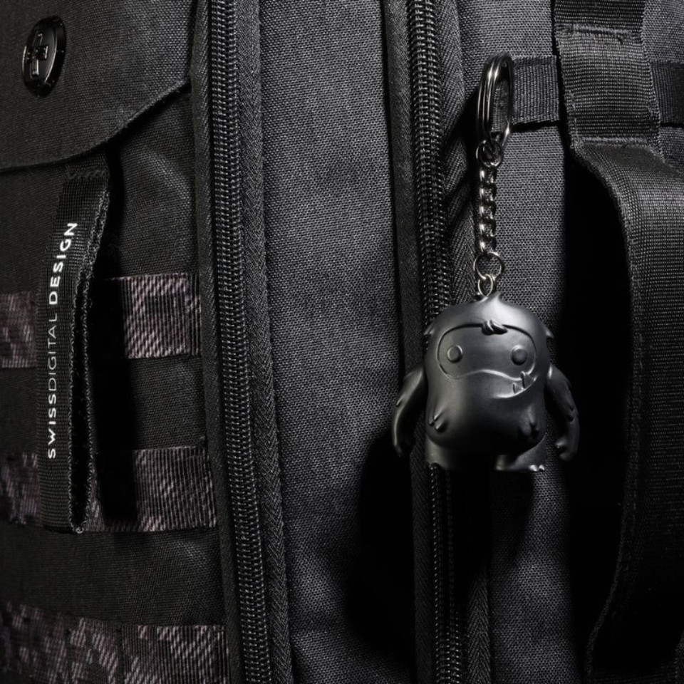 Black backpack with keychain accessory featuring cute black character.