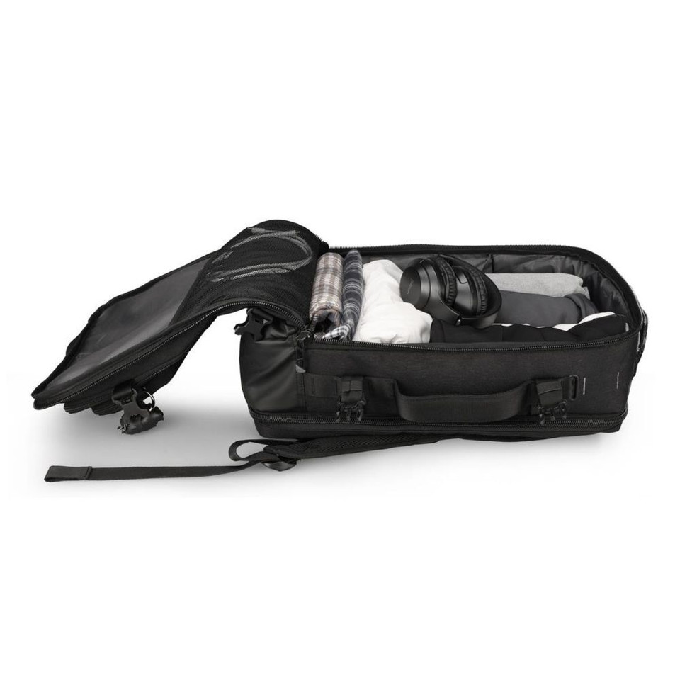 Open black travel bag packed with clothes and headphones.