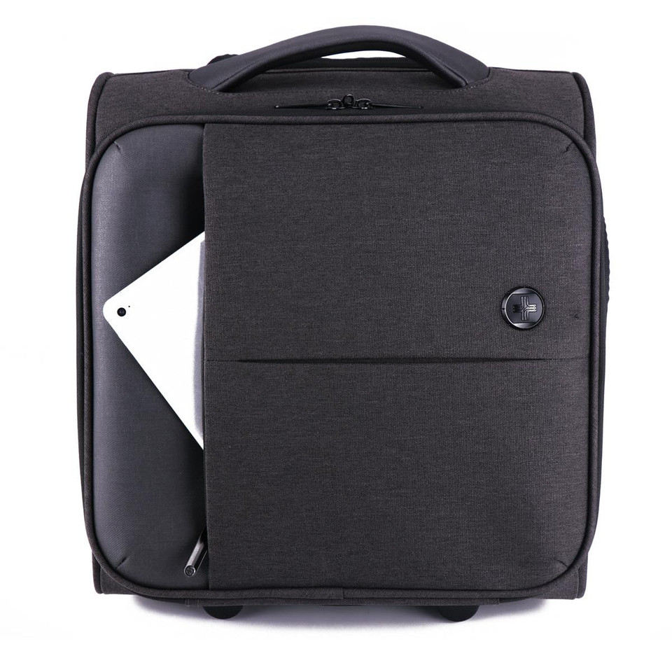 A dark grey wheeled bag with a front pocket, featuring a rounded handle and a logo.