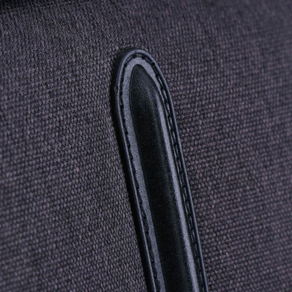 A close-up of a dark grey fabric with a black leather accent, part of the Swissdigital Arosa Duffle Bag.