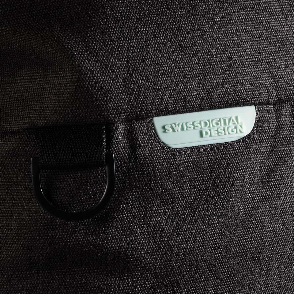 A black duffle bag featuring a light green logo tag and a metal loop attachment.