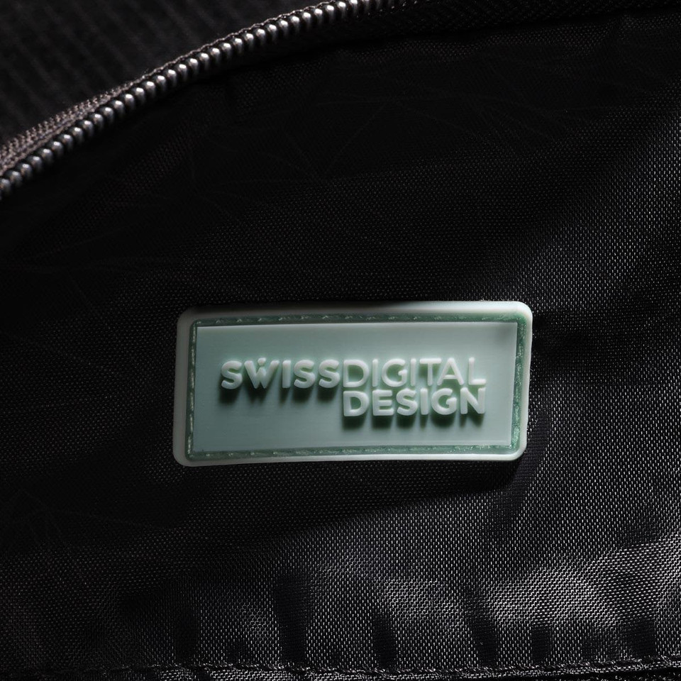 A close-up of the interior of a black duffle bag featuring a branded logo tag.