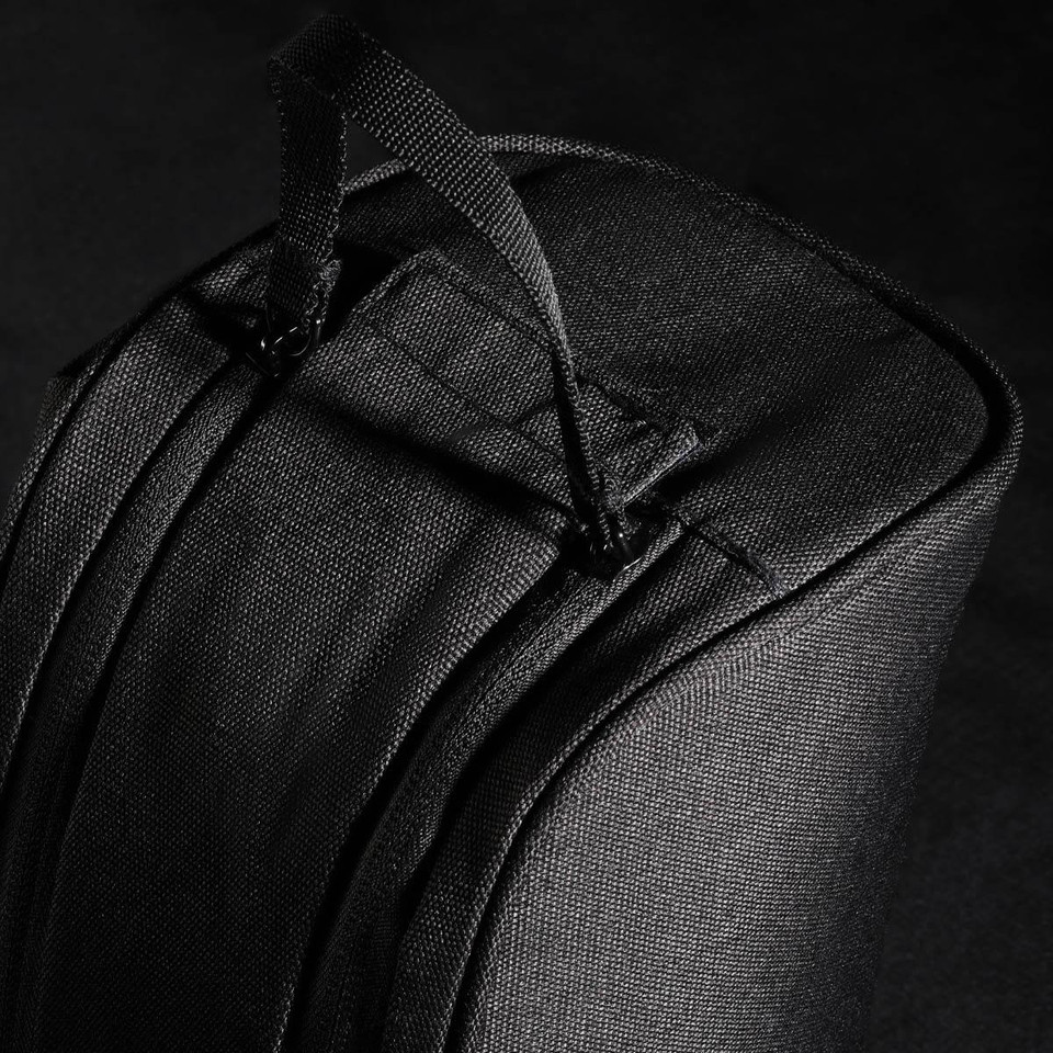 A black toiletry bag with a top handle and a sleek design, featuring a logo.