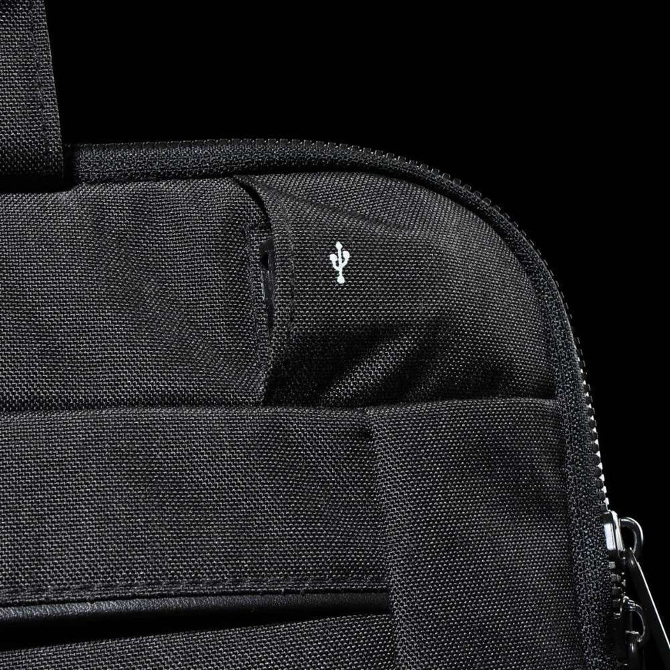 A black laptop sleeve featuring a small logo, showcasing a textured fabric and zip closure.
