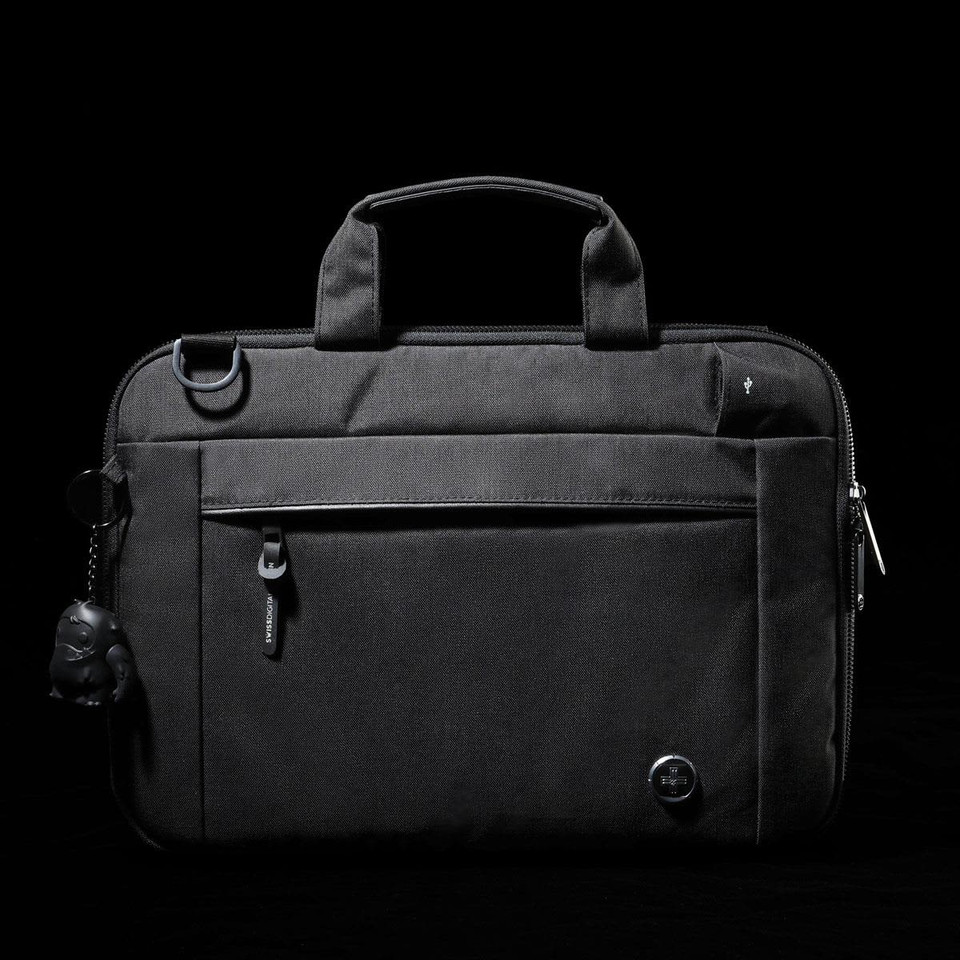 A black laptop sleeve with a zippered front pocket, handle, and a keychain accessory. It features a logo.