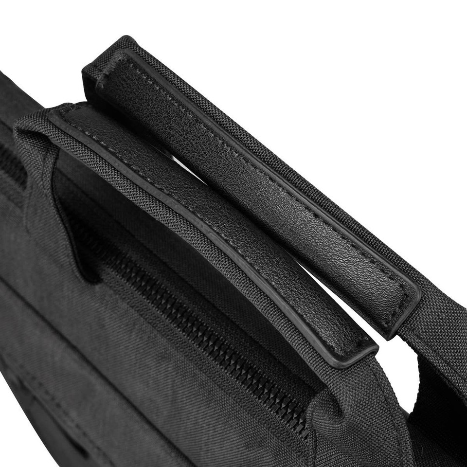 A black laptop sleeve with a textured surface and dual handles sits against a white background.
