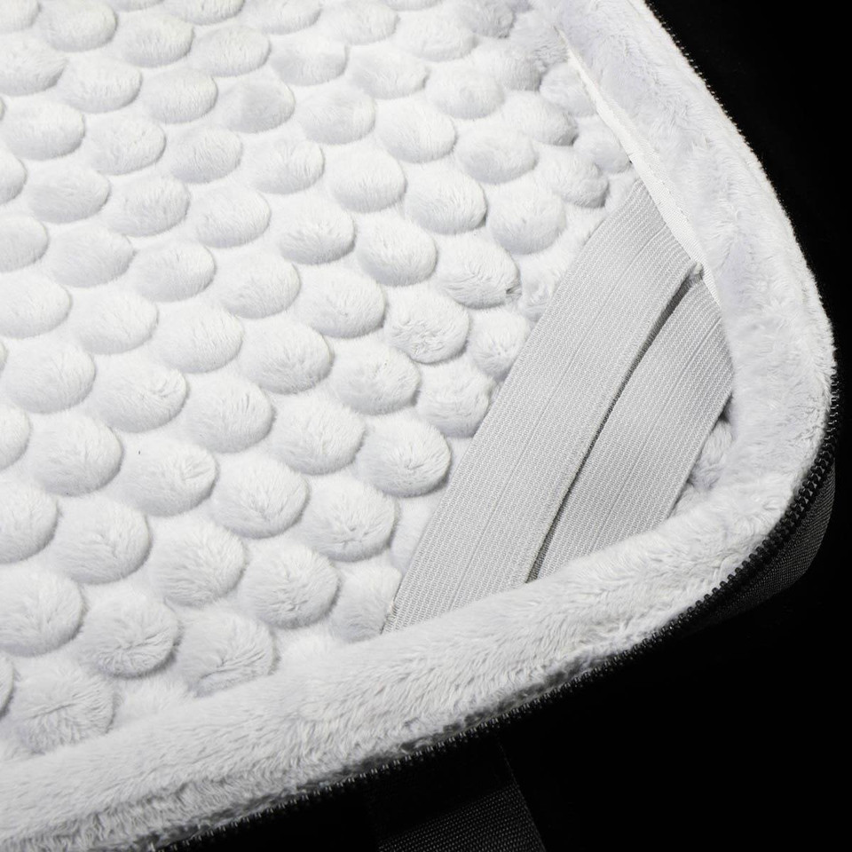 A close-up of a white padded interior of a laptop sleeve, featuring a textured surface and elastic straps.