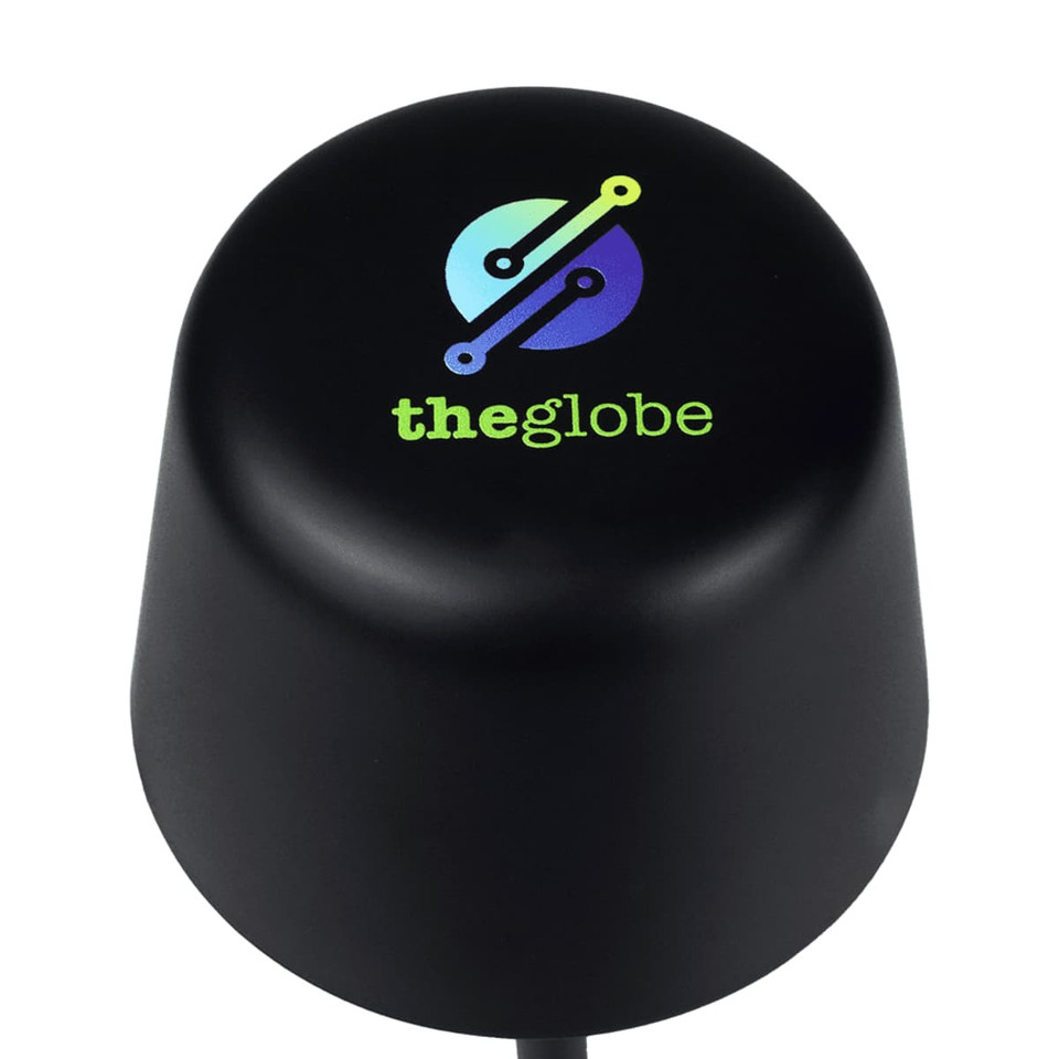 A black, rounded lamp with a logo on top, featuring blue and green colours. It is small and rechargeable.