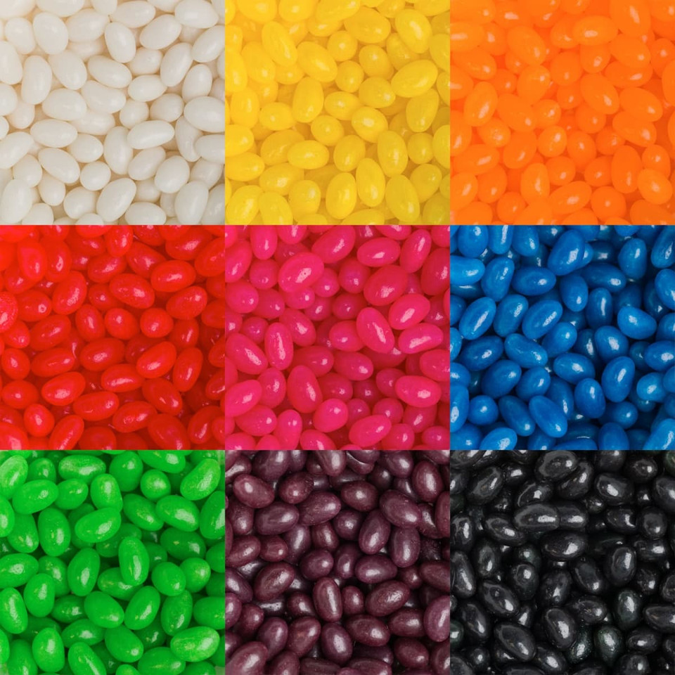 A collection of jelly beans in various colours, including white, yellow, orange, red, blue, green, pink, purple, and black.