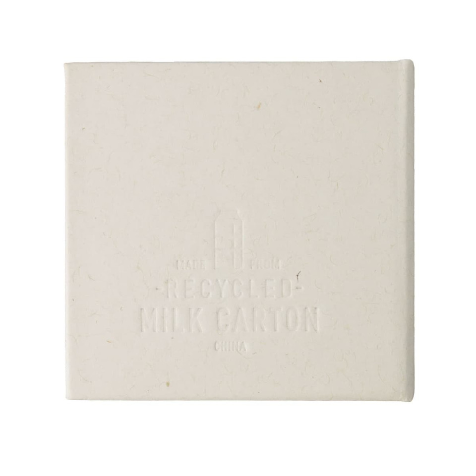 A square note block made from recycled materials, featuring a light cream colour and a subtle texture. It has a logo.