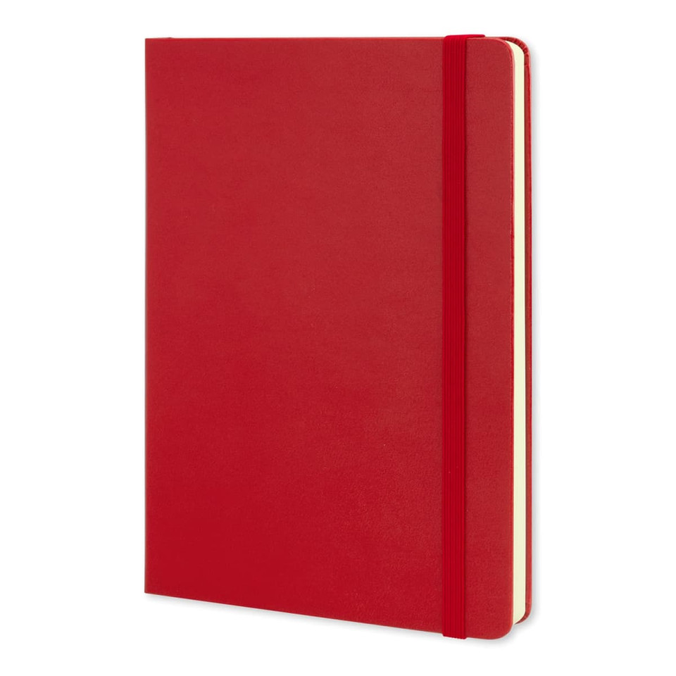 A large red Moleskine classic hard cover notebook with an elastic closure and blank pages.