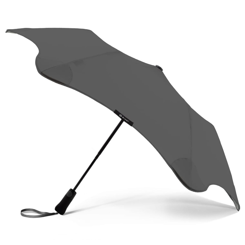 A grey BLUNT Metro Umbrella featuring a sleek design, a sturdy handle, and a distinctive shape.