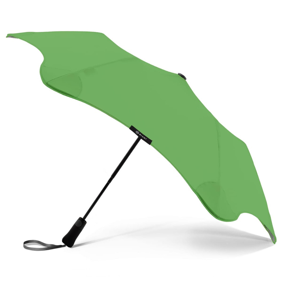 A green BLUNT Metro Umbrella featuring a sleek design and a black handle, with a branding logo.