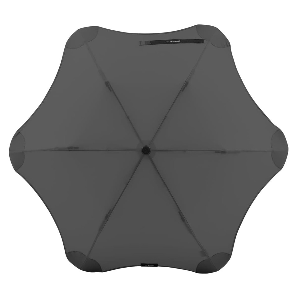 A black BLUNT Metro Umbrella with a unique rounded design and a central button for opening and closing.