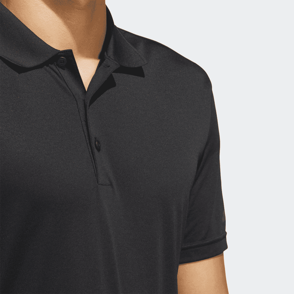 A black polo shirt with a collar and a button placket, featuring a logo on the sleeve.
