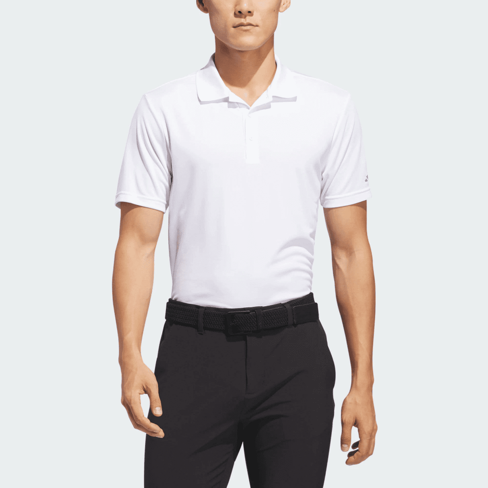 A white men's polo shirt with a collar, featuring a logo, paired with black trousers.