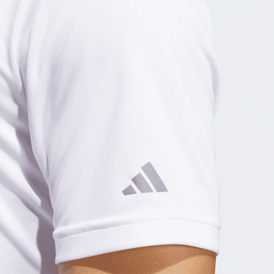 A white polo shirt featuring a logo on the sleeve, highlighting its recycled performance fabric.