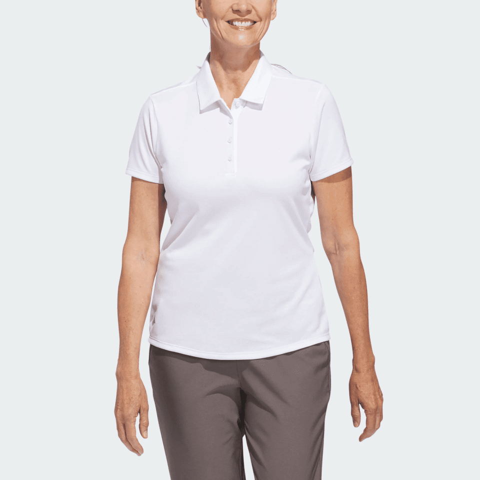 A white polo shirt for women, featuring a collar and short sleeves, with a logo on the chest.