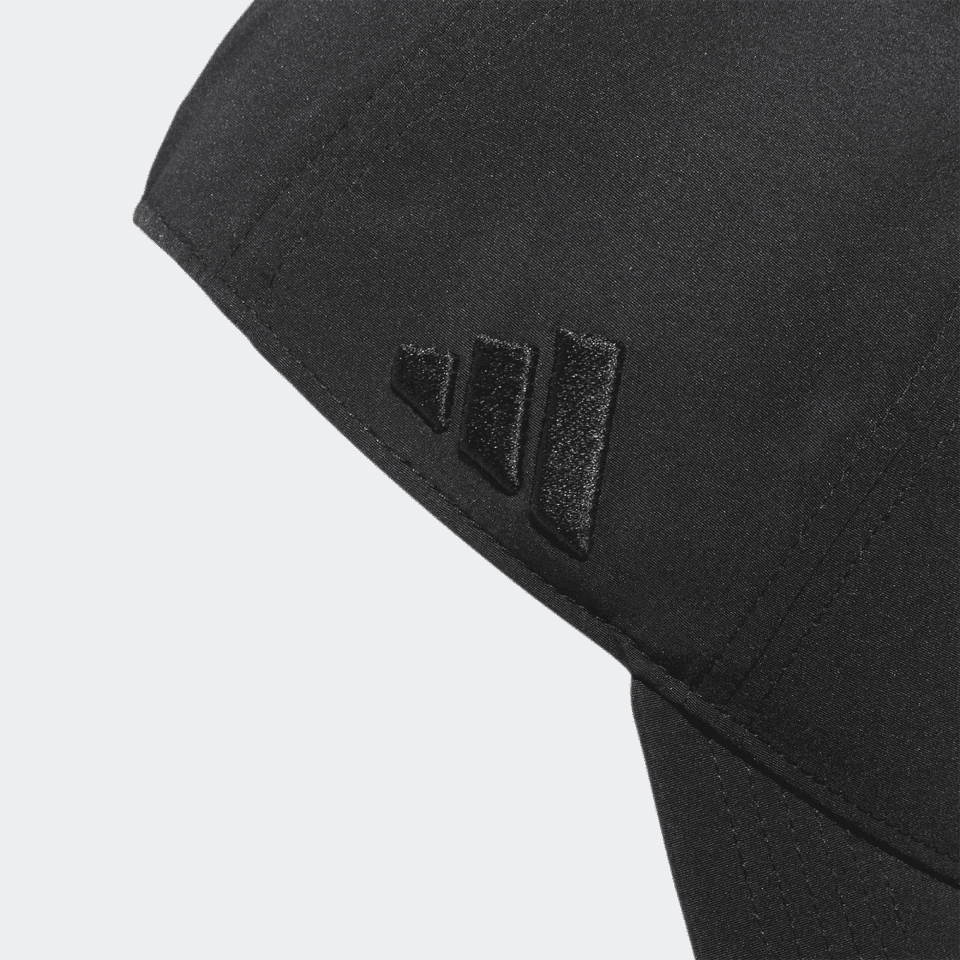 A black cap featuring a branded logo on the side, designed for performance in golf.