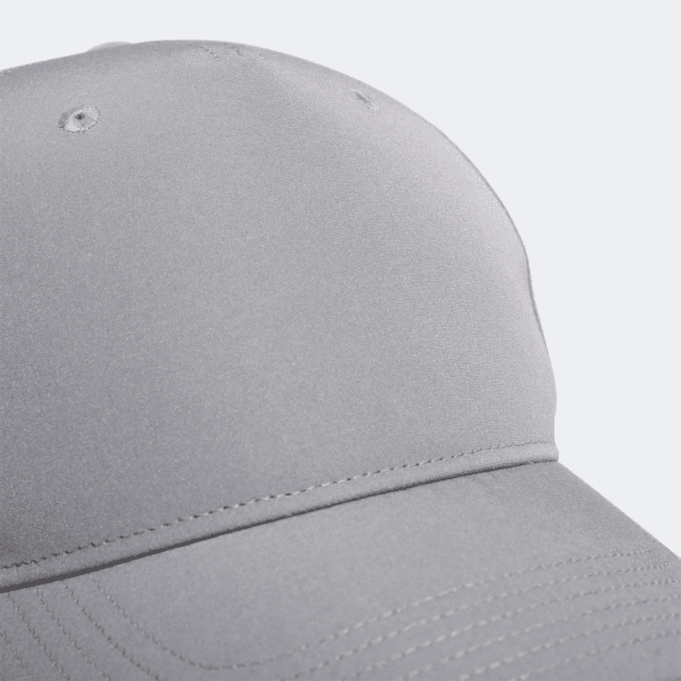 A grey Adidas performance golf cap featuring a smooth, sleek design and a branded logo.