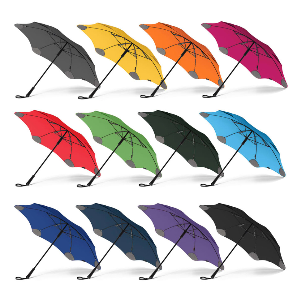 A collection of BLUNT Classic Umbrellas in various colours, including black, yellow, orange, red, green, blue, purple, and grey.