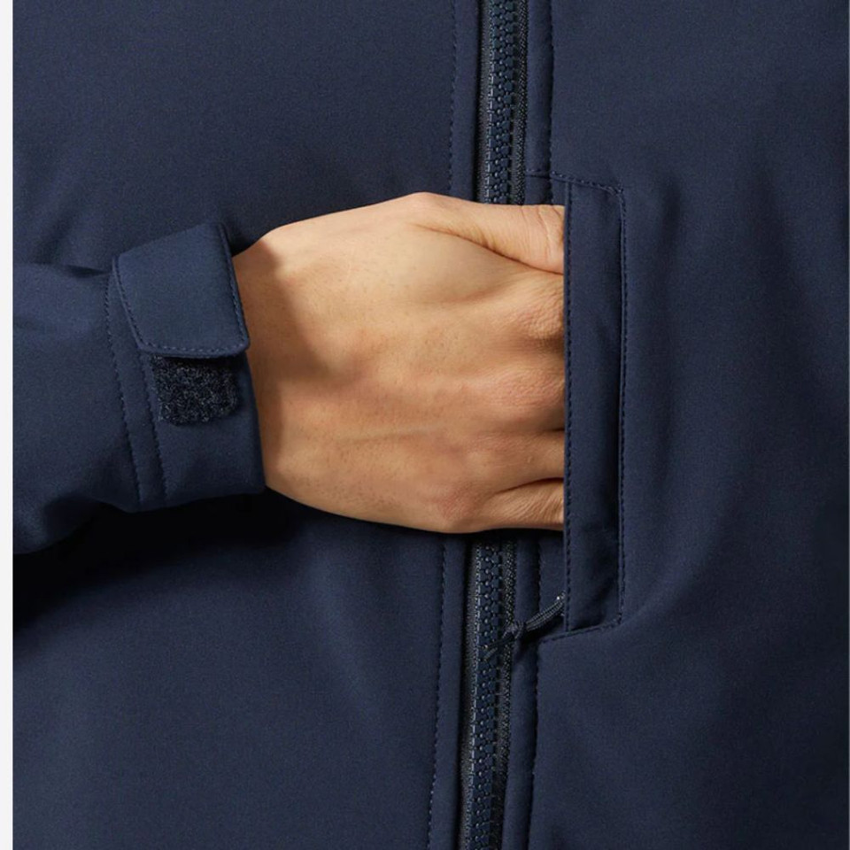 Detailed close-up of the navy women's softshell jacket featuring a zippered chest pocket, adjustable hook-and-loop cuff tab, and durable performance fabric.