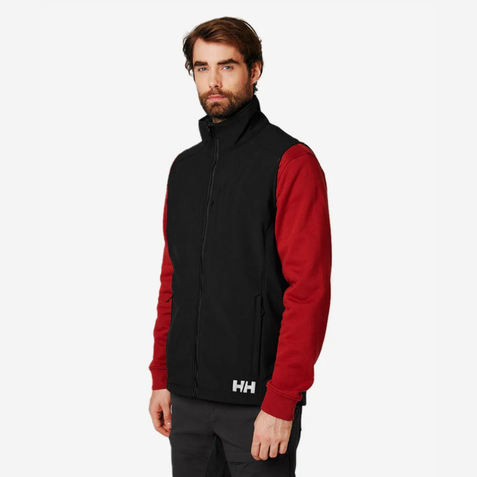 Man wearing  black Helly Hansen vest with a red jumper underneath.