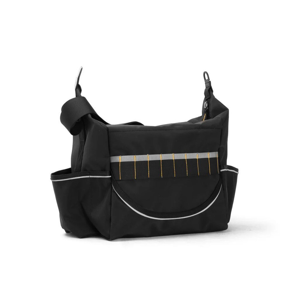 Black rugged crib bag with adjustable strap and front pocket, ideal for outdoor adventures., back view