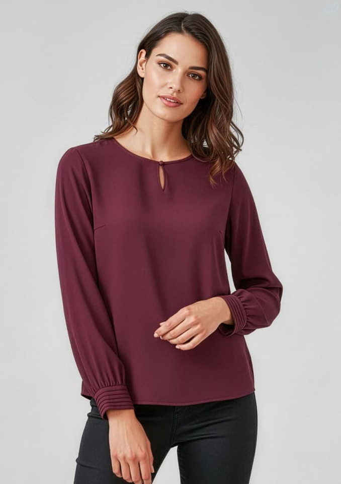 A burgundy long sleeve blouse with a round neckline and keyhole detail, featuring gathered sleeves.