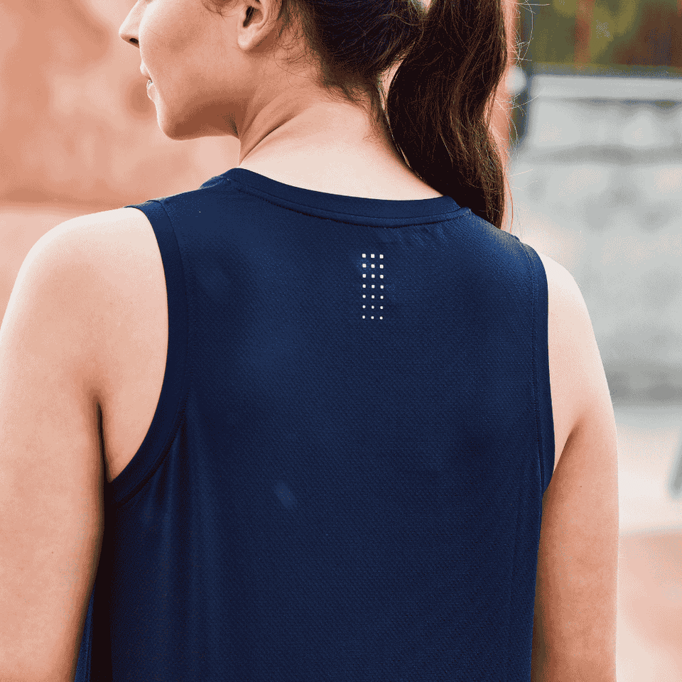 backside of a navy singlet worn by a woman with brown hair tied into a pony tail