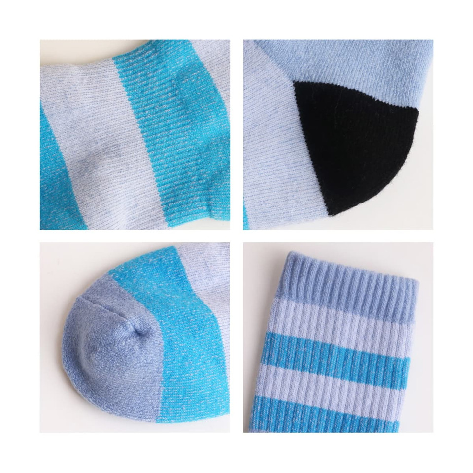 Merino wool socks featuring a light blue design with black and aqua accents, showcasing various sock details.