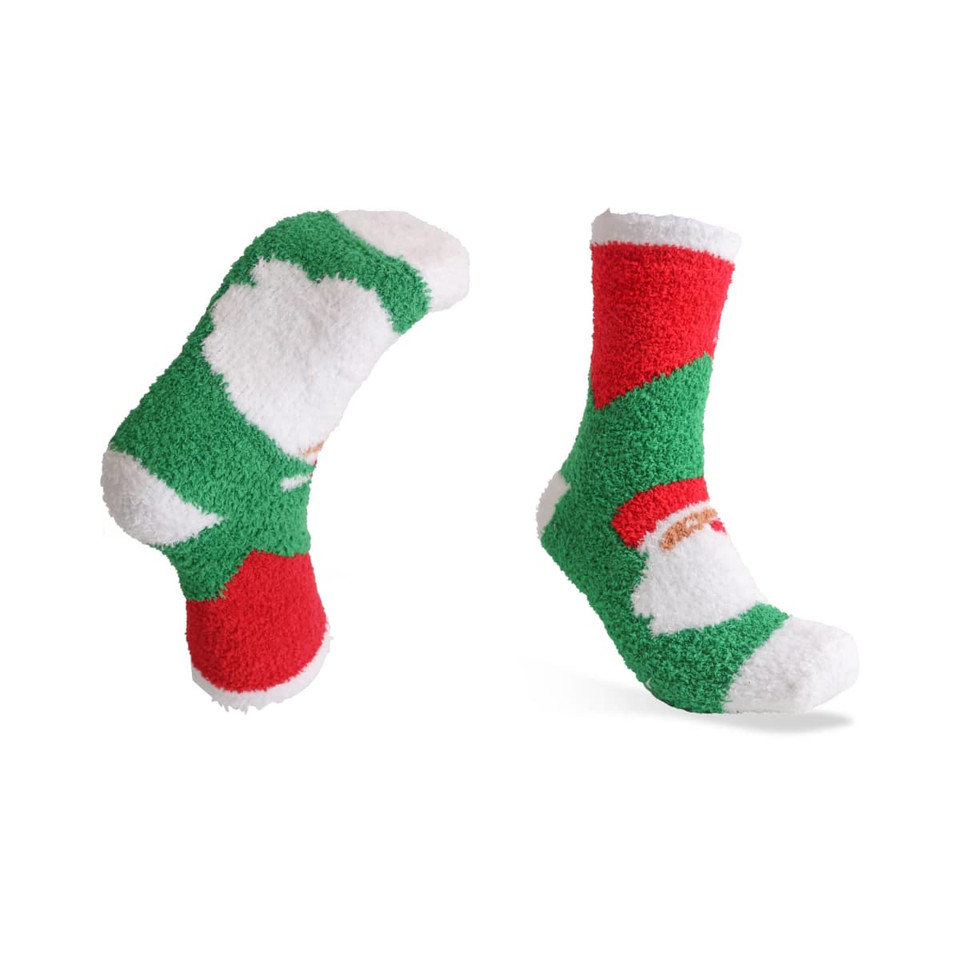 Fuzzy coral fleece socks featuring a festive design in red, green, and white with a logo on one sock.