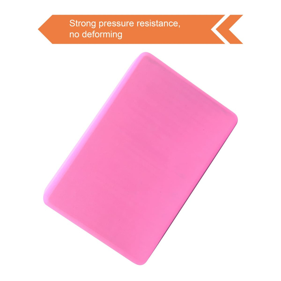 A pink EVA yoga block with a smooth surface. It features a logo and showcases strong pressure resistance.