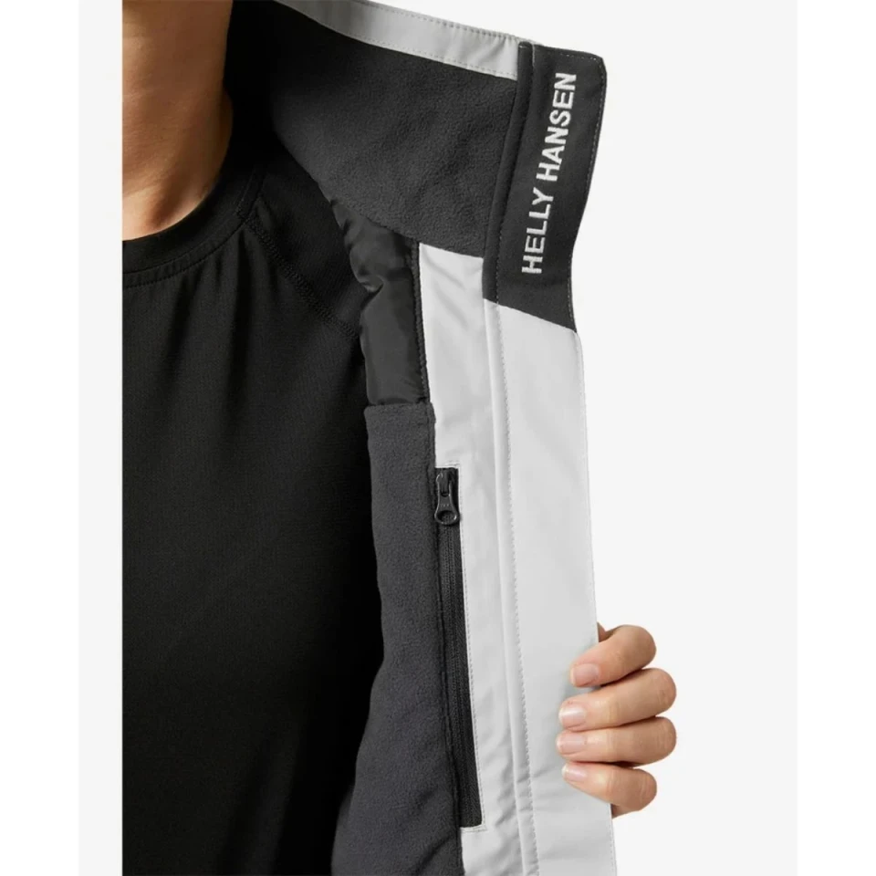 Interior detail of the Crew Women's Midlayer Jacket 2.0 in light grey featuring a fleece-lined collar, inner zip pocket, and Helly Hansen branded lining.