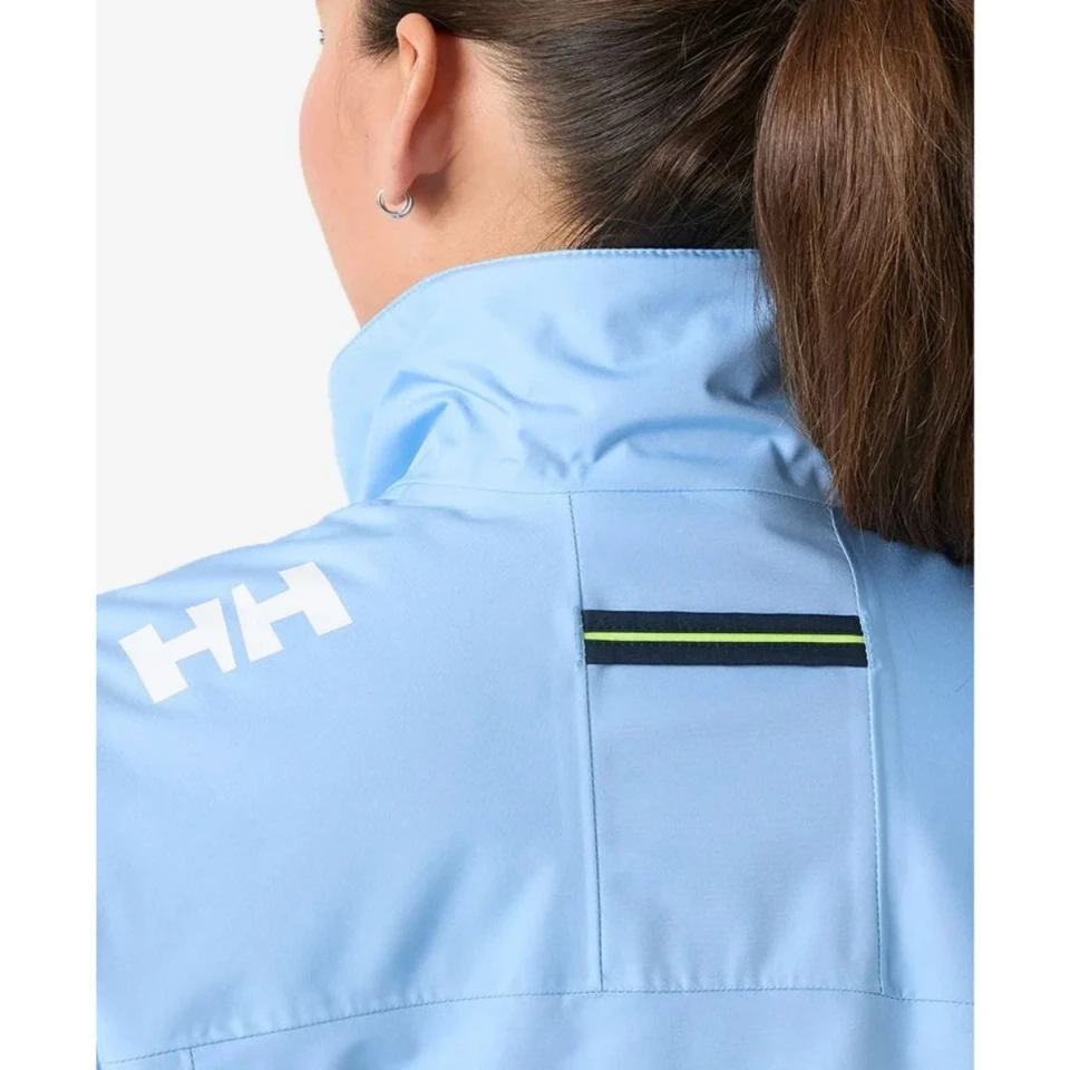 Rear shoulder close-up of the Crew Women's Midlayer Jacket 2.0 in light blue highlighting the HH logo, reflective back strip, and high stand-up collar.