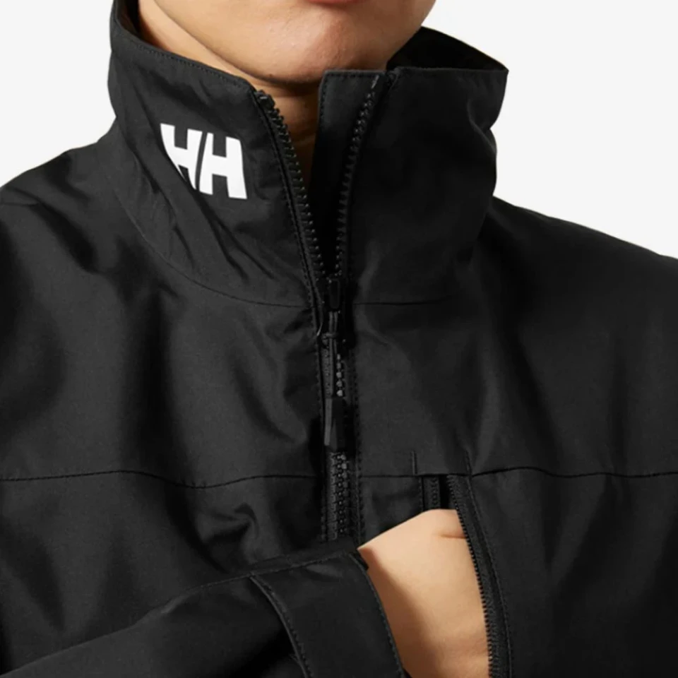 Close-up detail of the Crew Women's Midlayer Jacket 2.0 in black, featuring a high stand-up collar with HH logo branding, full-length zipper, and weather-resistant fabric construction.
