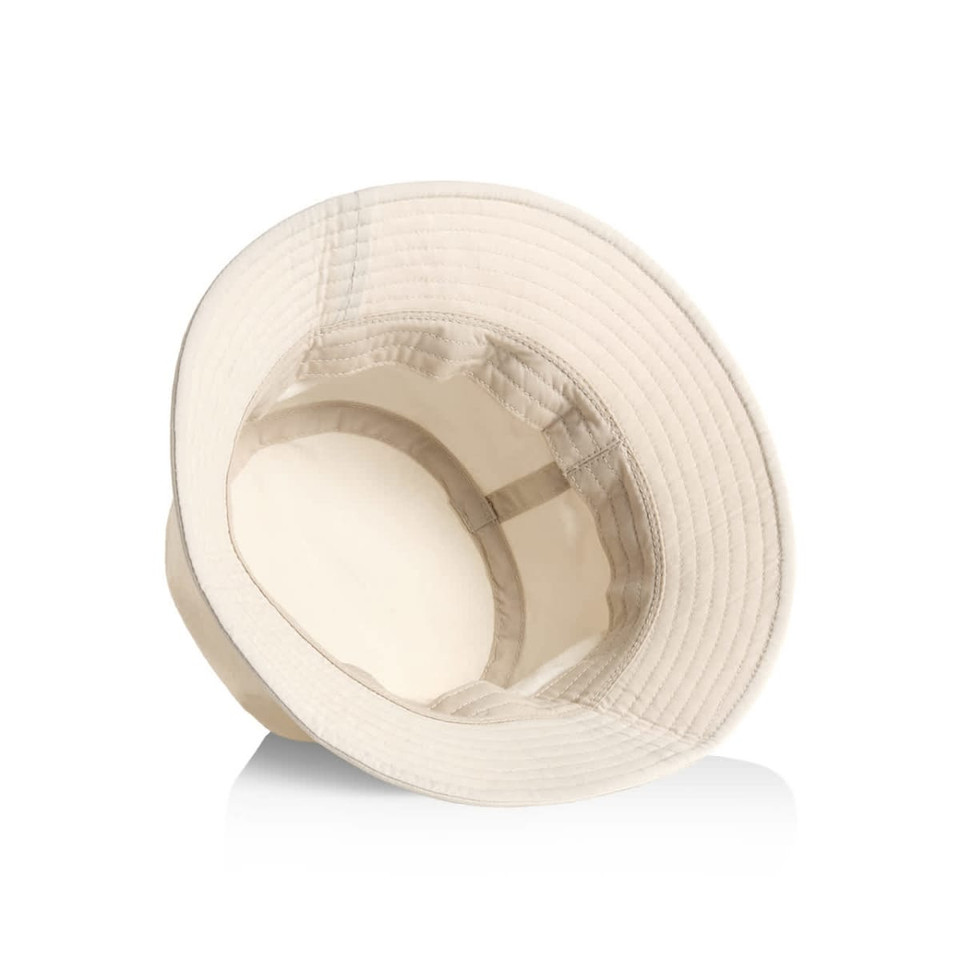 A nylon bucket hat in a light beige colour with a wide brim and an inner lining. It features a branded logo.