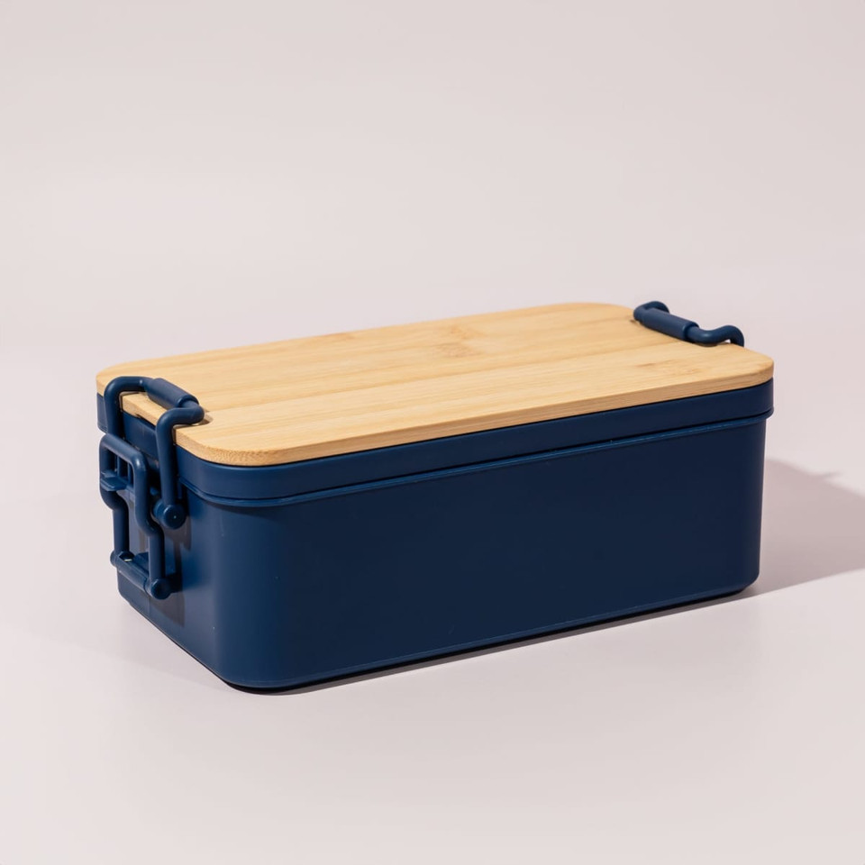 A navy blue lunch box with a bamboo lid and clips for secure closure. It features a minimalist design.
