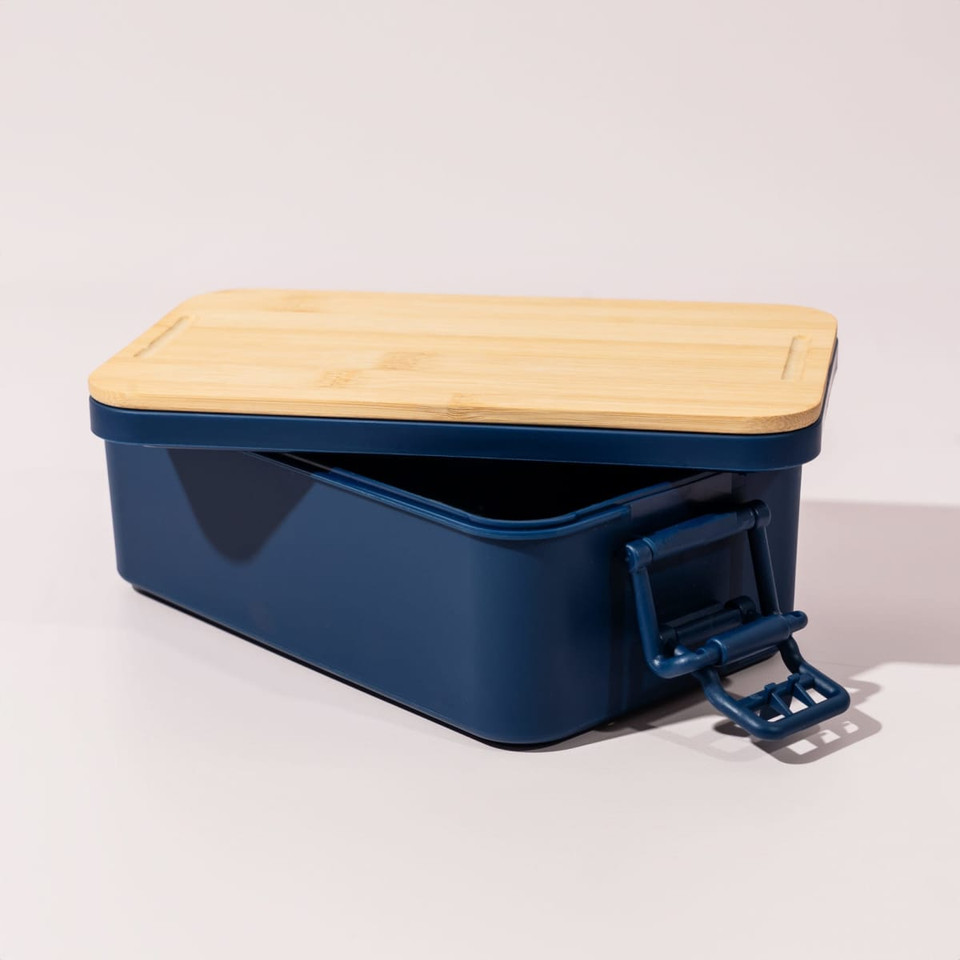 A navy double stack lunch box with a bamboo lid and a secure clasp. It has a sleek, modern design.