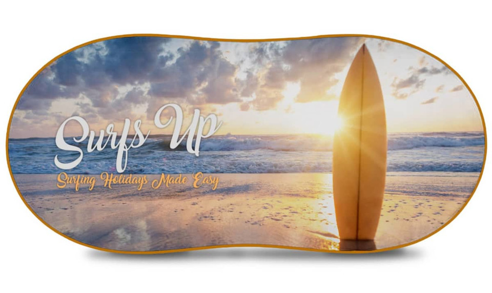 A full-colour sunshade featuring a surfboard on a beach at sunset with "Surfs Up" text and a logo.